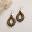 Handcrafted retro floral wooden earrings for women with colorful flower artwork and hollow teardrop design on a minimal neutral background.