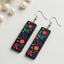 Rectangular wooden earrings with colorful floral folk design on black base for women