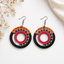 Tribal circular wooden earrings for women with black red orange geometric pattern and hollow center design