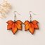 Autumn maple leaf wooden earrings for women featuring vibrant orange fall leaf artwork with lightweight fish hook ear wires.