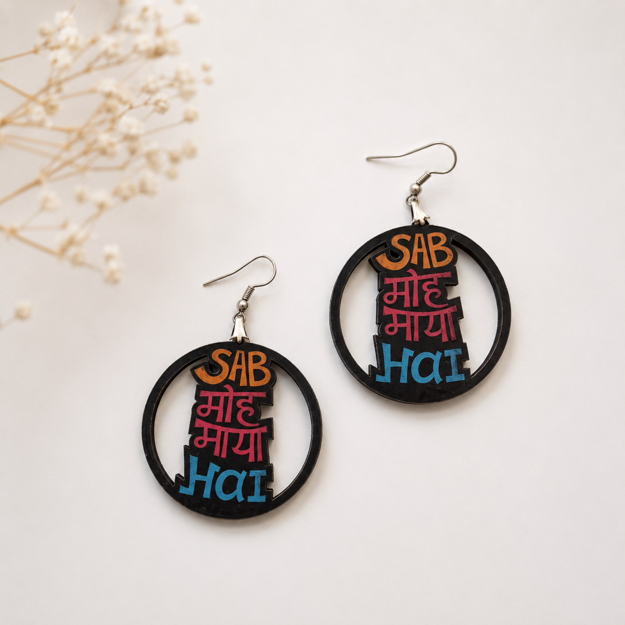 Handcrafted Sab Moh Maya Hai wooden earrings for women with colorful Hindi typography and circular statement design on a minimal neutral background. Main image