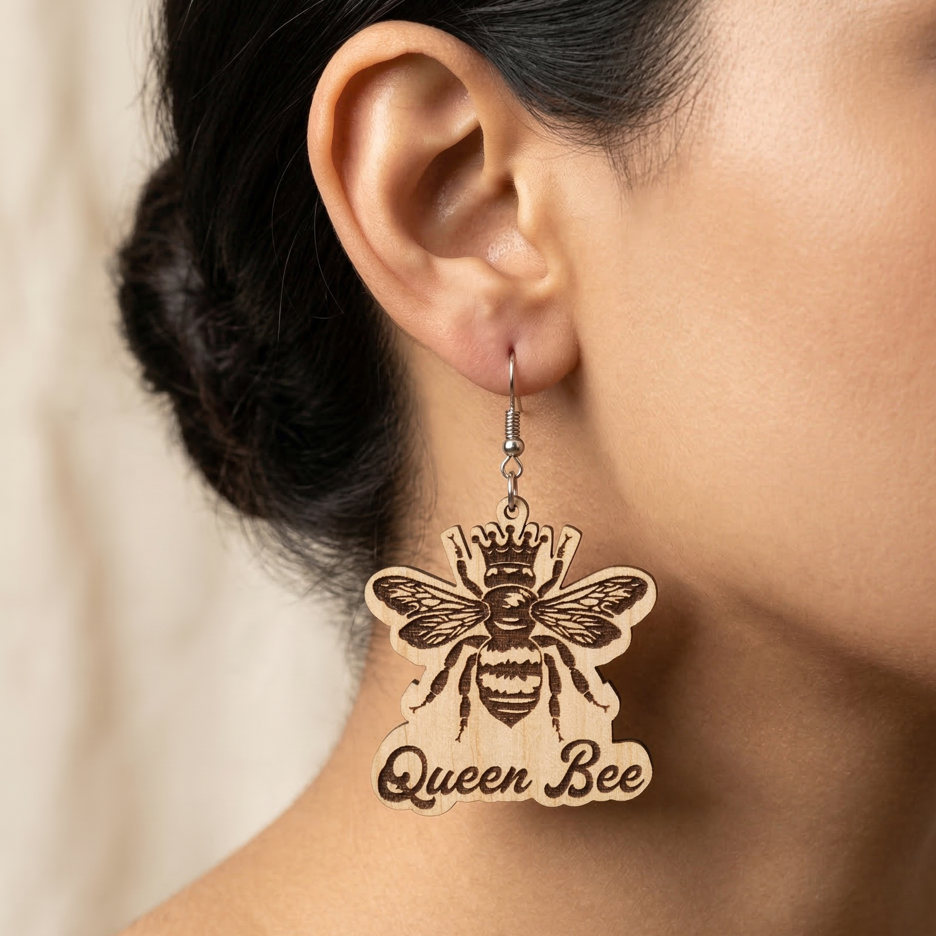 Queen Bee wooden drop earrings featuring a detailed bee, a crown, and cursive Queen Bee text Main image