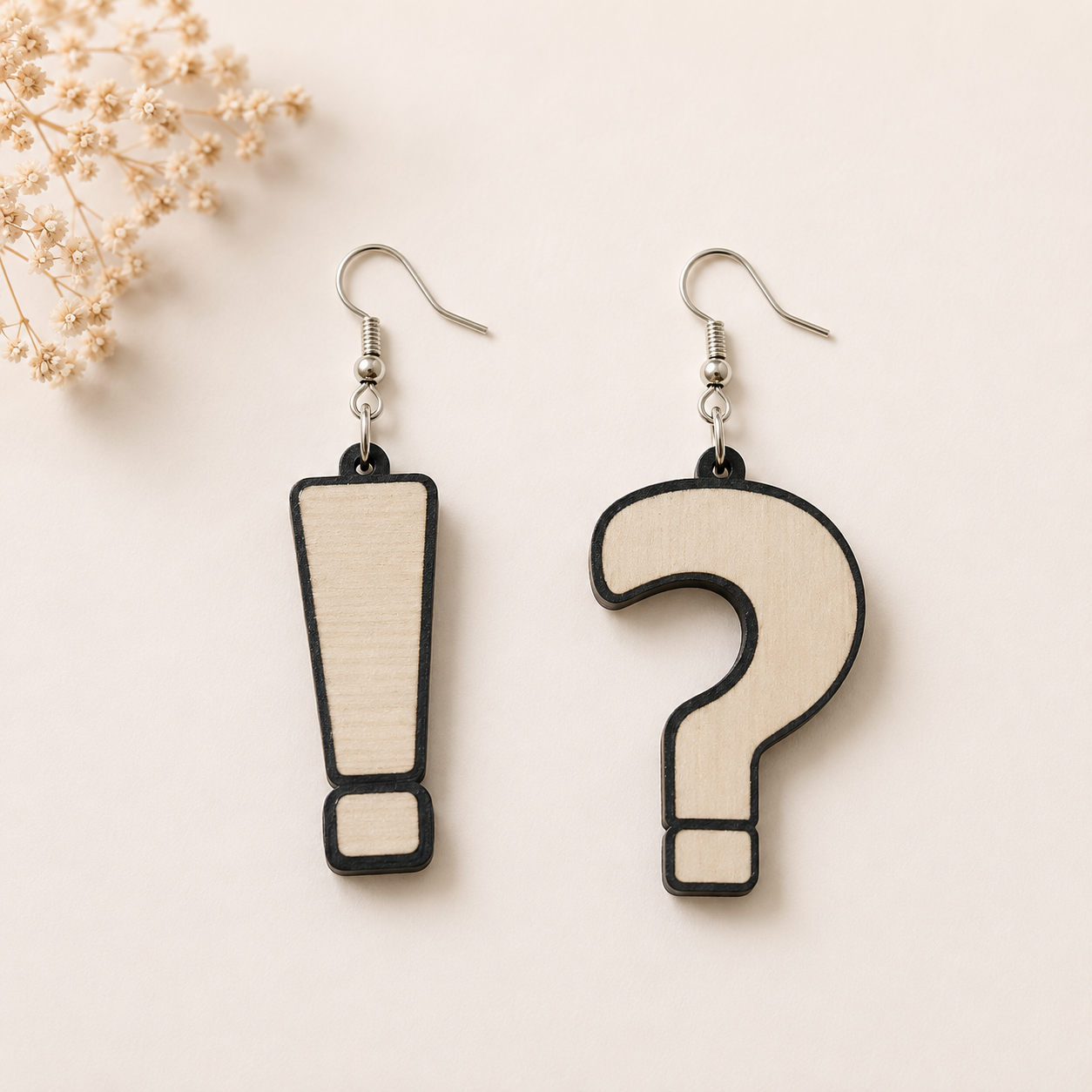Quirky wooden earrings for women featuring mismatched exclamation mark and question mark designs with natural wood finish and lightweight fish hook ear wires.