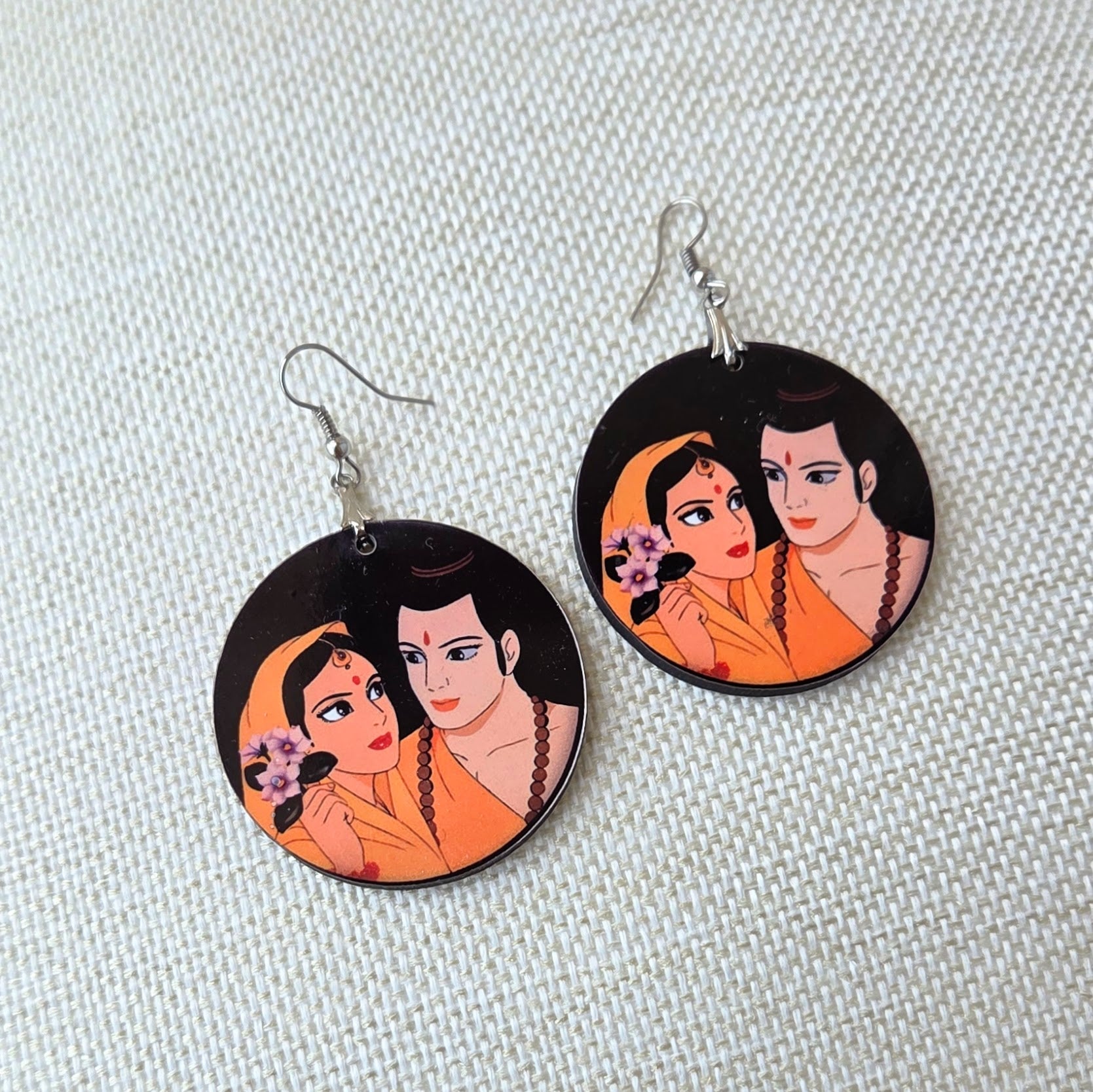 Ram and Sita wooden earrings for women featuring traditional Ramayana-inspired artwork in a lightweight round design with fish hook ear wires.