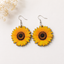 Realistic sunflower wooden earrings with golden yellow petals and brown center
