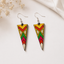 Sunset chevron wooden triangle dangle earrings with yellow, red, green and pink pattern
