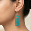 Teal rectangular wooden drop earrings with a botanical fern leaf cutwork design